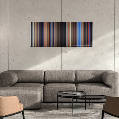 Poltergeist color palette canvas on a concrete wall above a gray sectional sofa