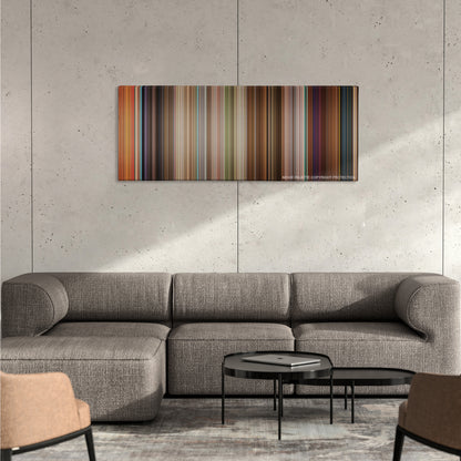 Enchanted color palette canvas on a concrete wall above a gray sectional sofa