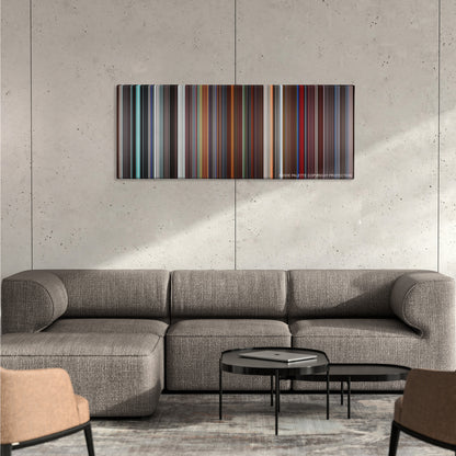 The Aviator color palette canvas on a concrete wall above a gray sectional sofa