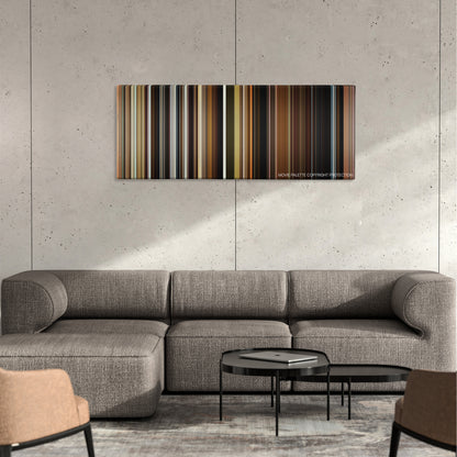 The Visit color palette canvas on a concrete wall above a gray sectional sofa
