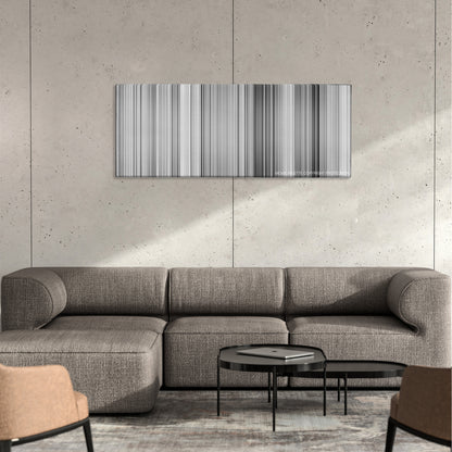 The Kid color palette canvas on a concrete wall above a gray sectional sofa