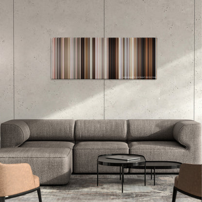 Parker color palette canvas on a concrete wall above a gray sectional sofa