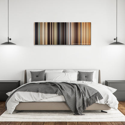 I Origins color palette canvas above a bed, between two black pendant lamps