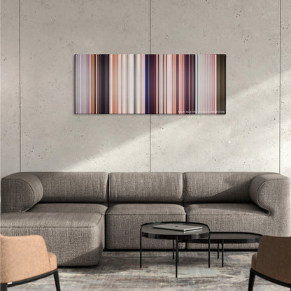 Cars color palette canvas on a concrete wall above a gray sectional sofa