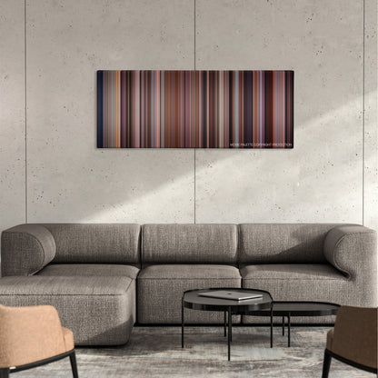 Pay It Forward color palette canvas on a concrete wall above a gray sectional sofa