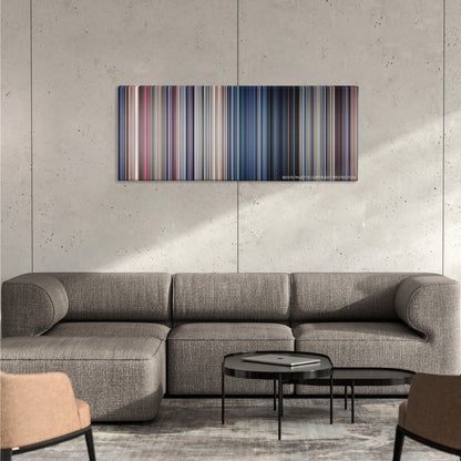 Jurassic Park color palette canvas on a concrete wall above a gray sectional sofa