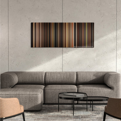 The Godfather color palette canvas on a concrete wall above a gray sectional sofa