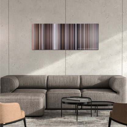 The Good, the Bad and the Ugly color palette canvas on a concrete wall above a gray sectional sofa