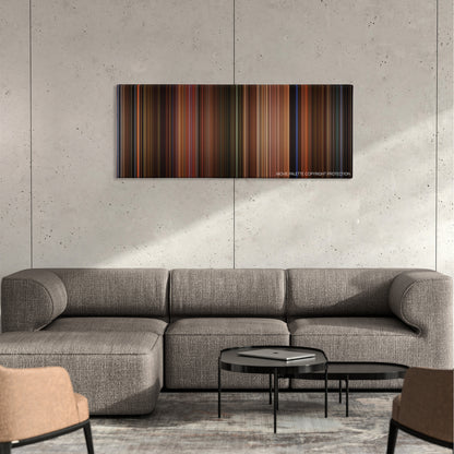 The Dreamers color palette canvas on a concrete wall above a gray sectional sofa