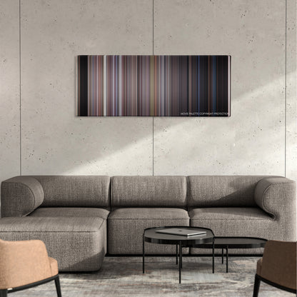 The Faculty color palette canvas on a concrete wall above a gray sectional sofa