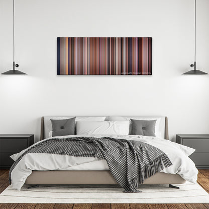 Pay It Forward color palette canvas above a bed, between two black pendant lamps