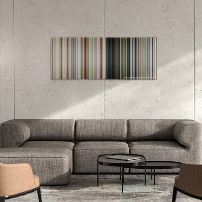 District 9 color palette canvas on a concrete wall above a gray sectional sofa