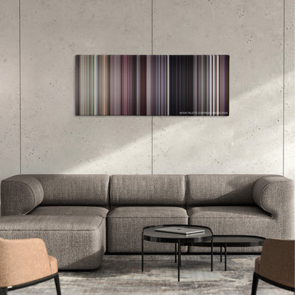 The Whole Nine Yards color palette canvas on a concrete wall above a gray sectional sofa