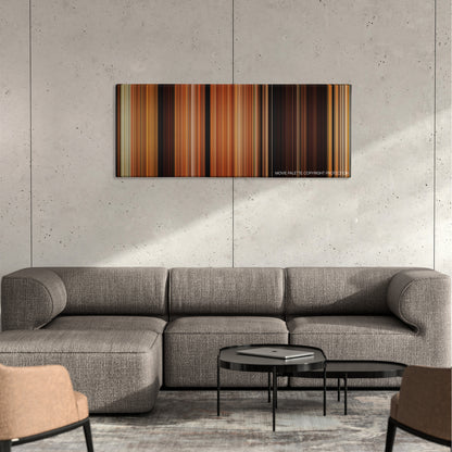 Coherence color palette canvas on a concrete wall above a gray sectional sofa