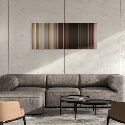 Superbad color palette canvas on a concrete wall above a gray sectional sofa