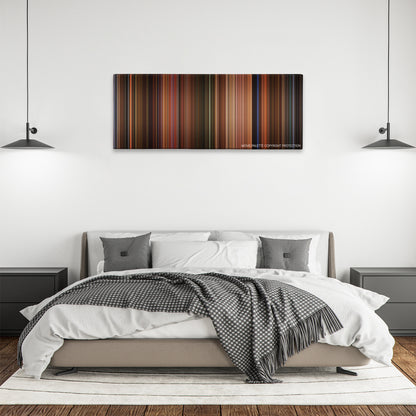 The Dreamers color palette canvas above a bed, between two black pendant lamps
