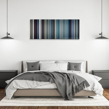 The French Connection color palette canvas above a bed, between two black pendant lamps