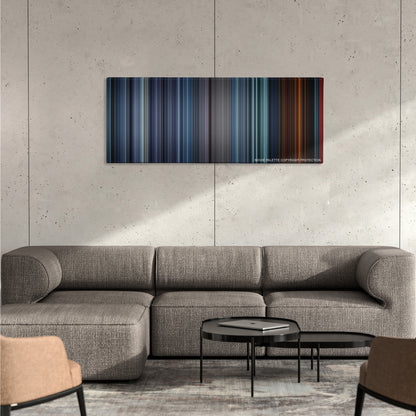 Fury color palette canvas on a concrete wall above a gray sectional sofa