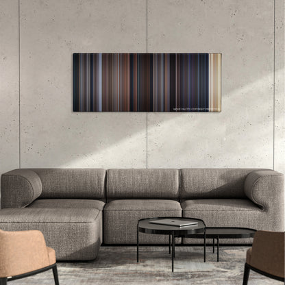 Entrapment color palette canvas on a concrete wall above a gray sectional sofa