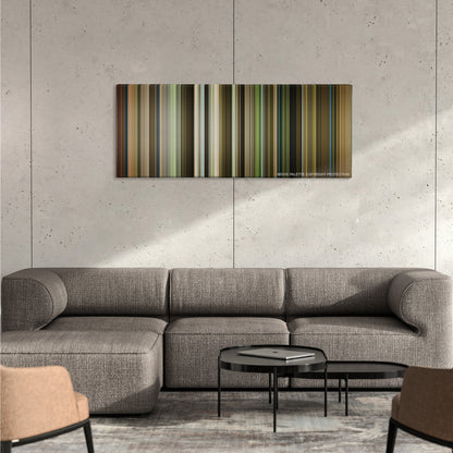 Green Book color palette canvas on a concrete wall above a gray sectional sofa