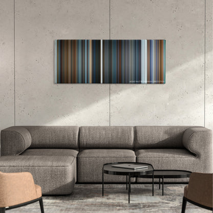 What Happened to Monday color palette canvas on a concrete wall above a gray sectional sofa