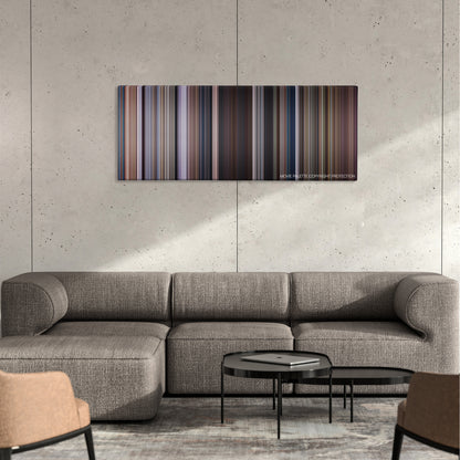 Men of Honor color palette canvas on a concrete wall above a gray sectional sofa