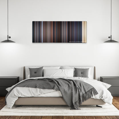 Entrapment color palette canvas above a bed, between two black pendant lamps
