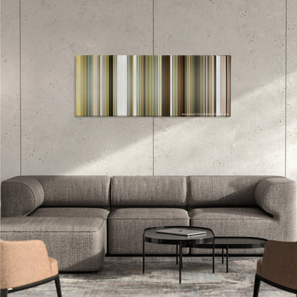 Bruce Almighty color palette canvas on a concrete wall above a gray sectional sofa