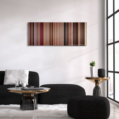 27 Dresses color palette canvas above a black sofa with a gold-topped table