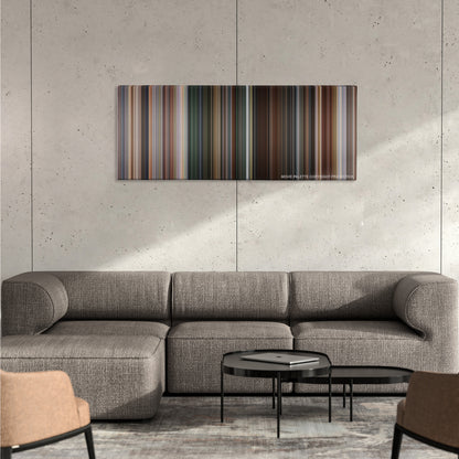 Face/Off color palette canvas on a concrete wall above a gray sectional sofa