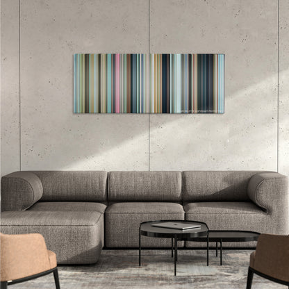 3 Idiots color palette canvas on a concrete wall above a gray sectional sofa