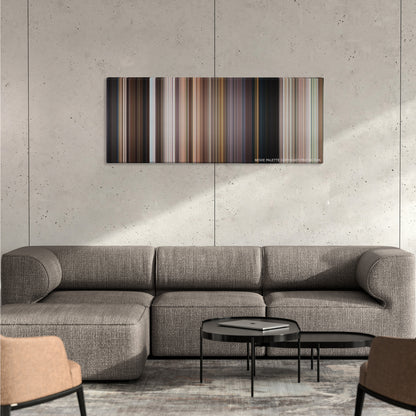Men in Black 3 color palette canvas on a concrete wall above a gray sectional sofa