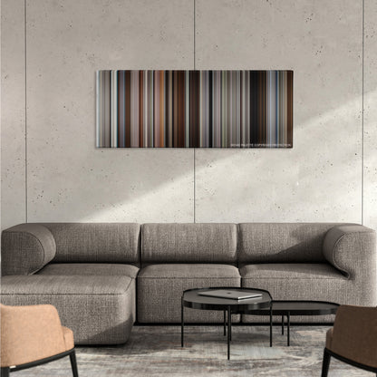50/50 color palette canvas on a concrete wall above a gray sectional sofa