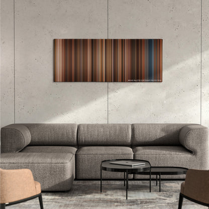 Night at the Museum color palette canvas on a concrete wall above a gray sectional sofa