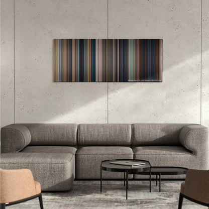 Jack Reacher color palette canvas on a concrete wall above a gray sectional sofa