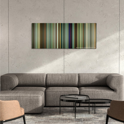 Tenet color palette canvas on a concrete wall above a gray sectional sofa