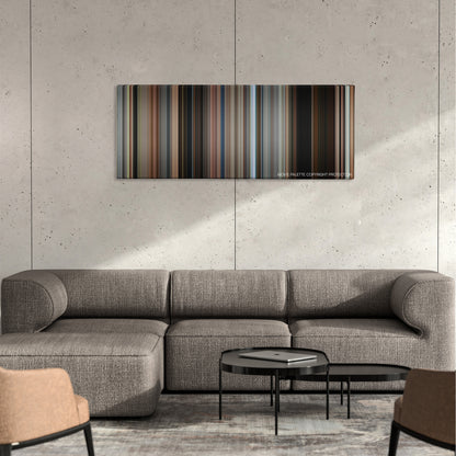 The Edge of Seventeen color palette canvas on a concrete wall above a gray sectional sofa